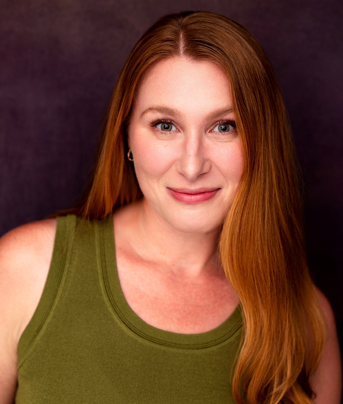 Lydia Wassan, headshot on a plum background